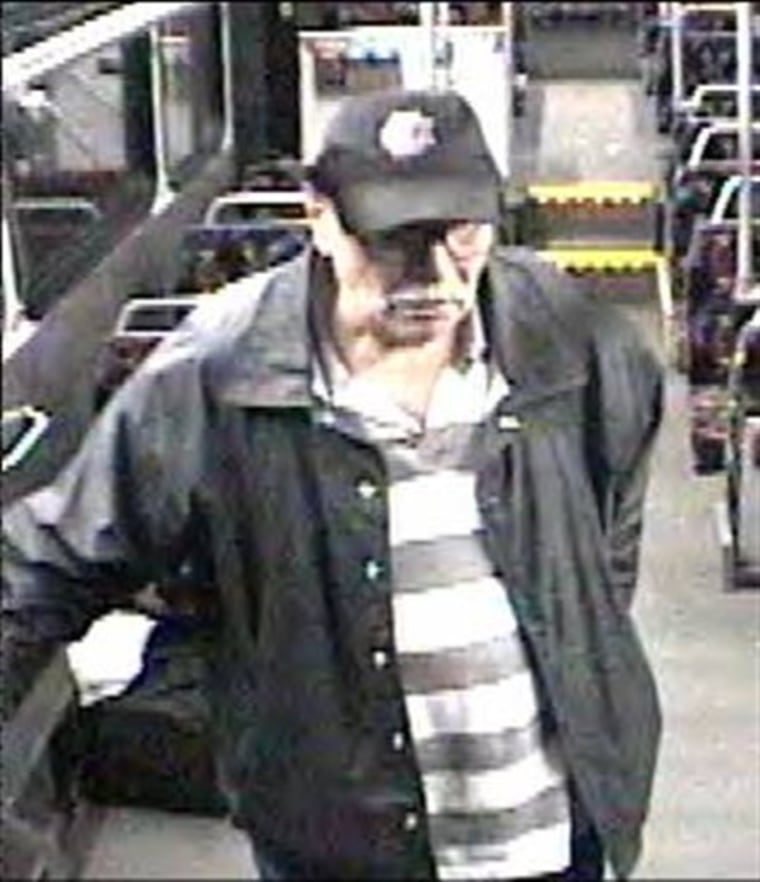 The FBI released this photo taken from surveillance video on Friday, April 22, 2011, of a suspect riding a bus on Tuesday, April 19, 2011, who is wanted for questioning in connection with a fire and the placing of a pipe bomb at Southwest Plaza Mall in Littleton, Colo., earlier in the week. (AP Photo/FBI)